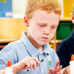boy using glue for craft
