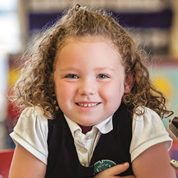 young girl smiling in uniform