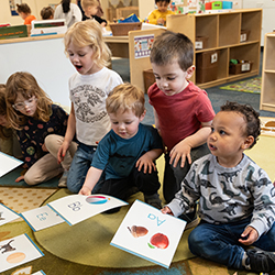 Group of kids looking at letter cards
