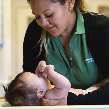 teacher laying infant down