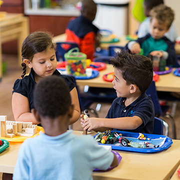 kids working on activities at the classroom tables 