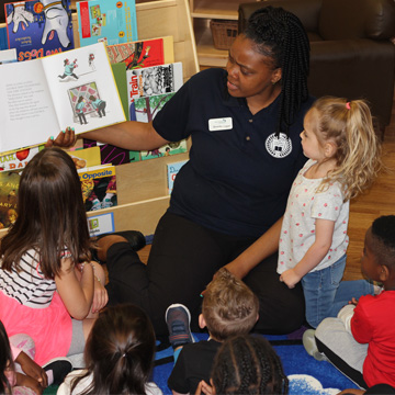 teacher reading to group of kids
